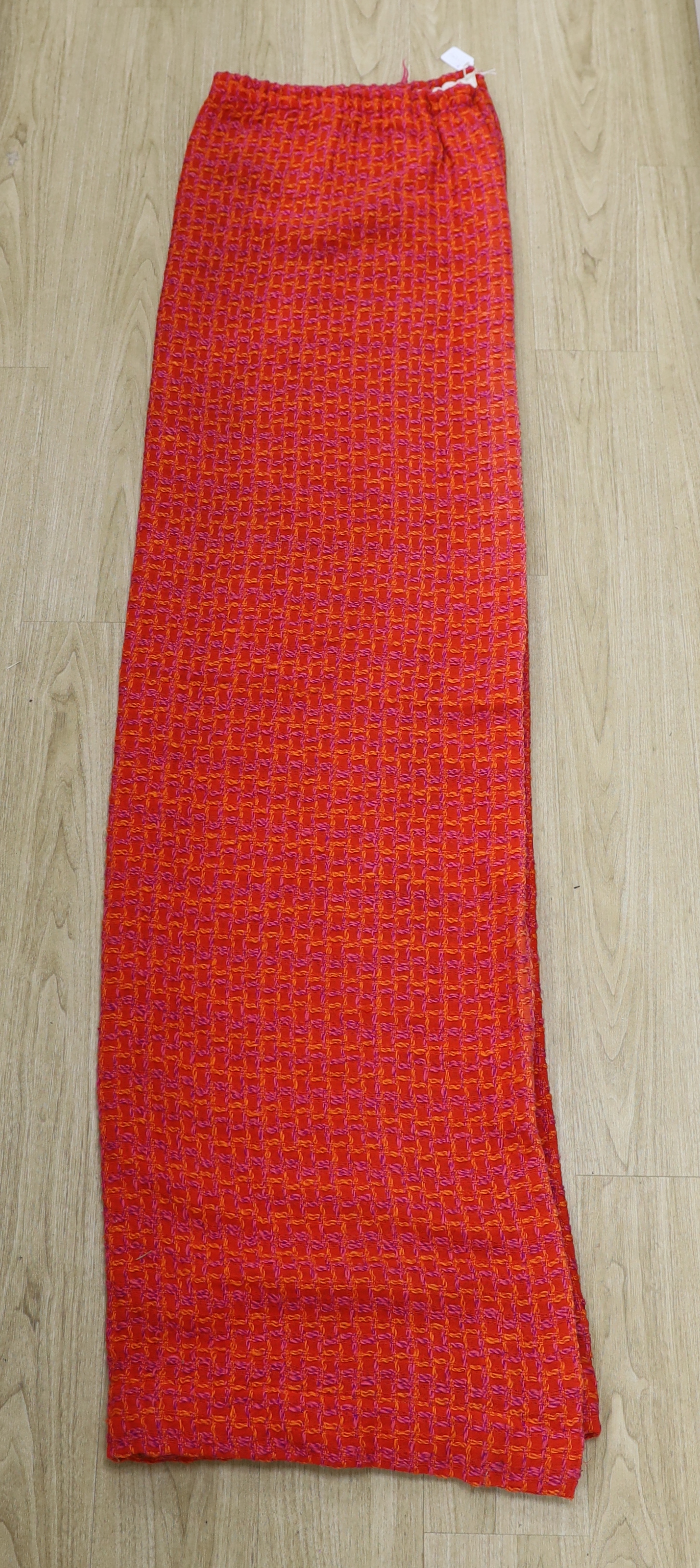 An unusual woven 1960's curtain in orange, pink and purple wools in a square overall pattern